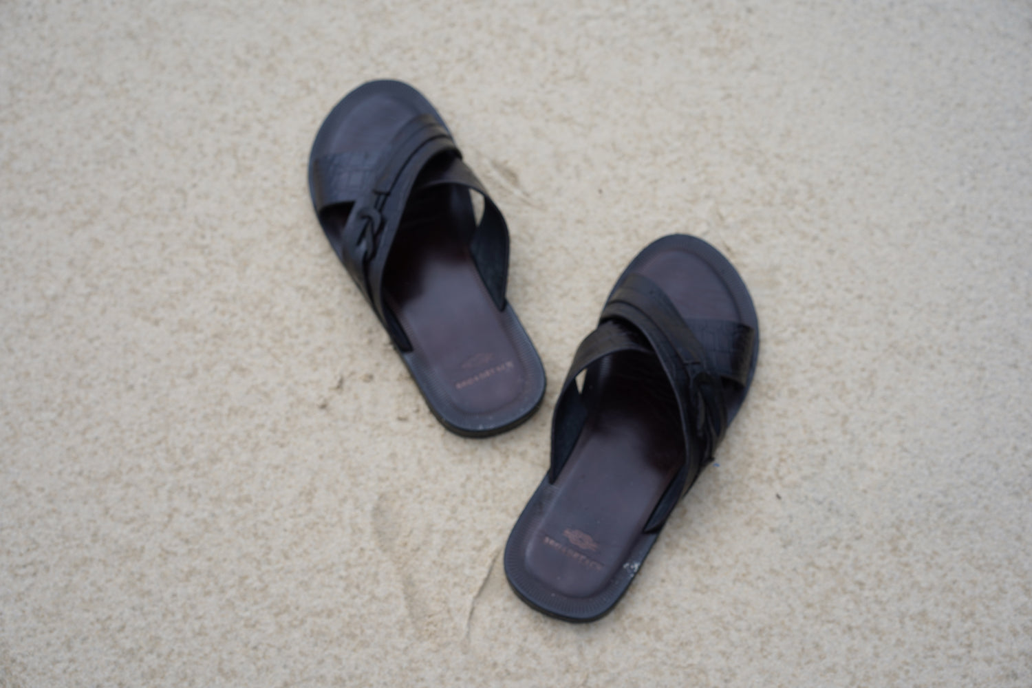 Image of men’s leather Lagoon sandals by BroadReach resort wear against sand backdrop.